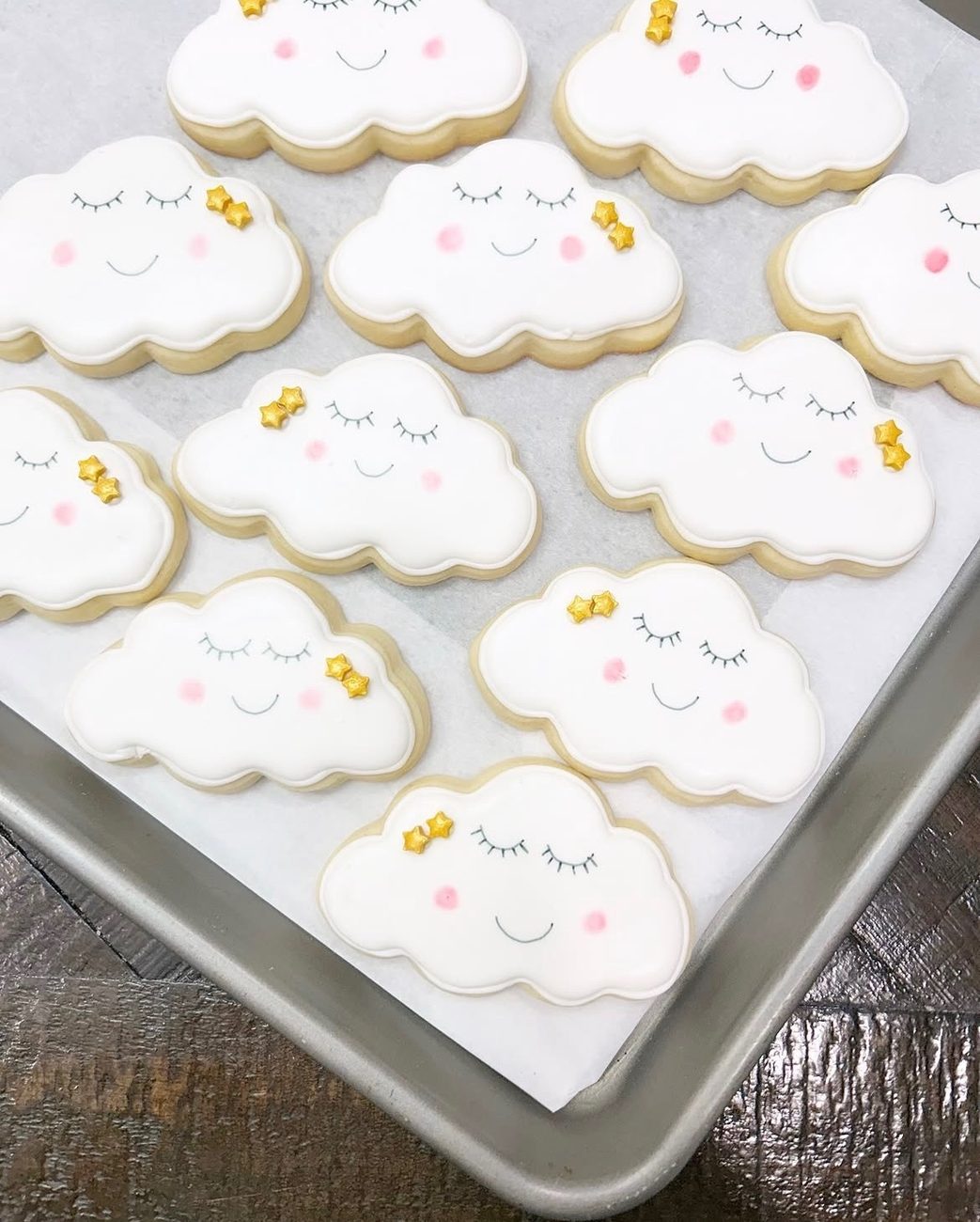 White cloud cookies with sleepy faces, pink cheeks and gold stars